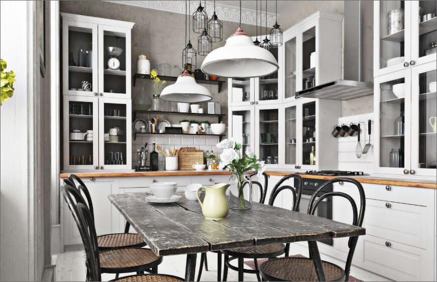 retro mutfakta, beyaz mutfak dolaplari ve koyu renk ahsap yemek masasi ve sandalye takimi, endustriyel sarkit lamba